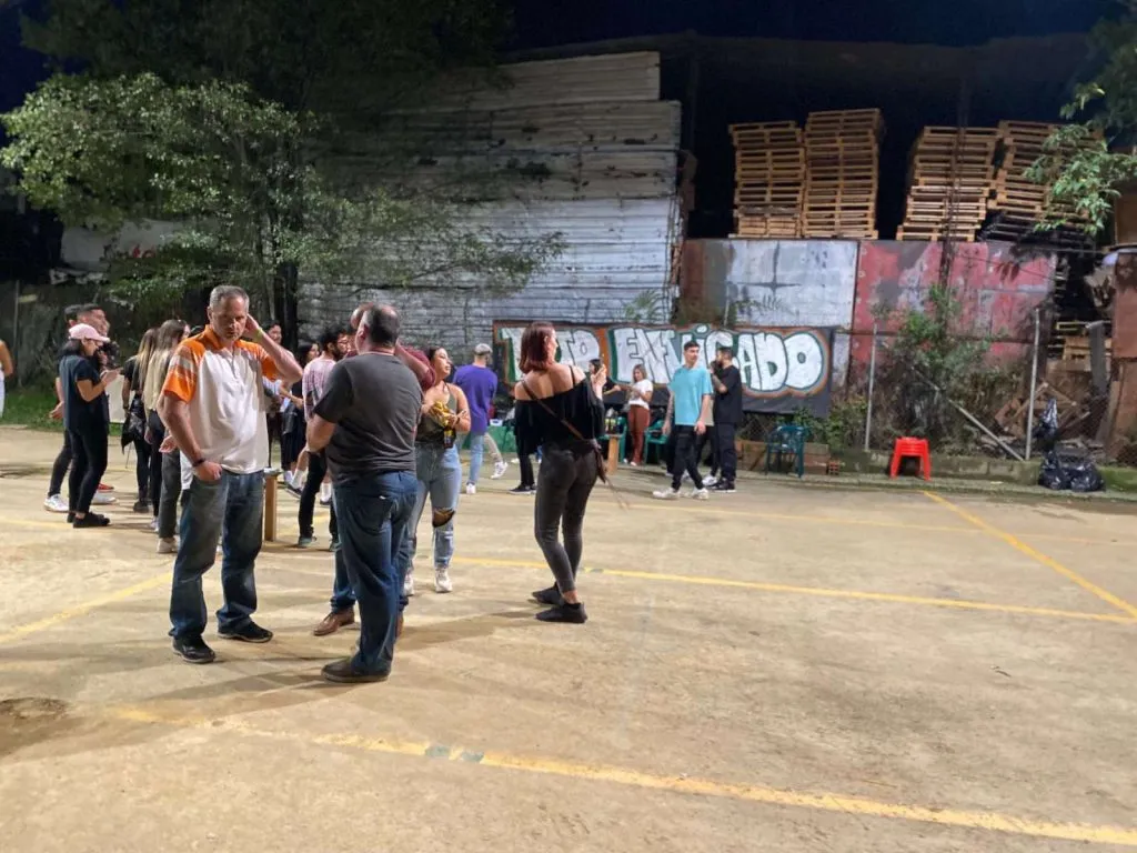 Outdoor gathering with people socializing at night