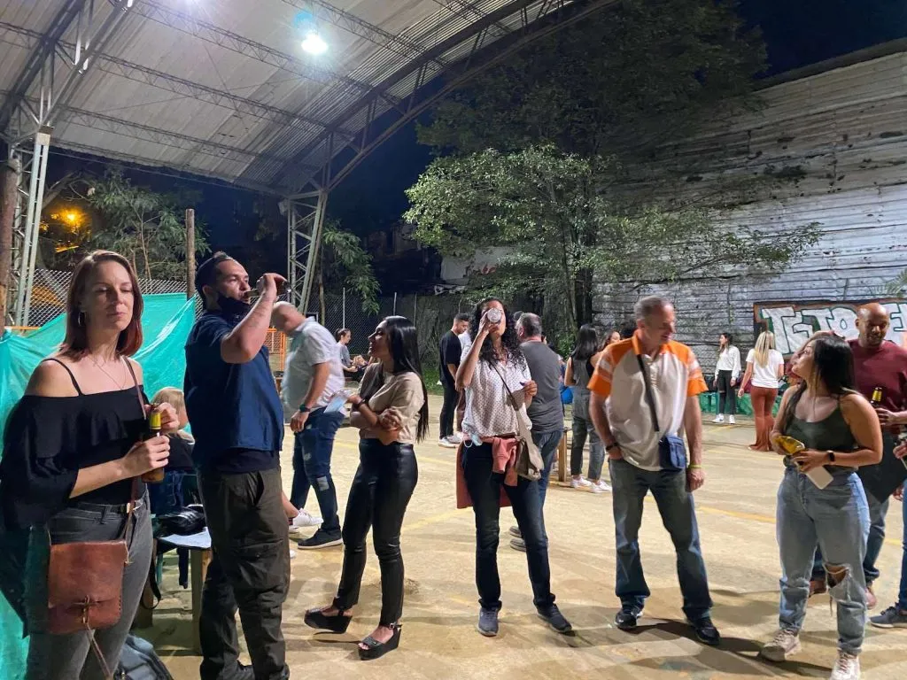 Group socializing at outdoor evening event.