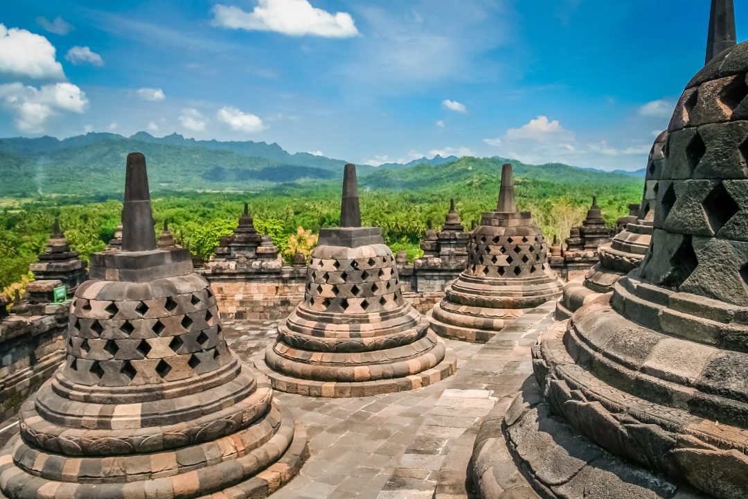 Borobudur Temple stupas with green landscape view