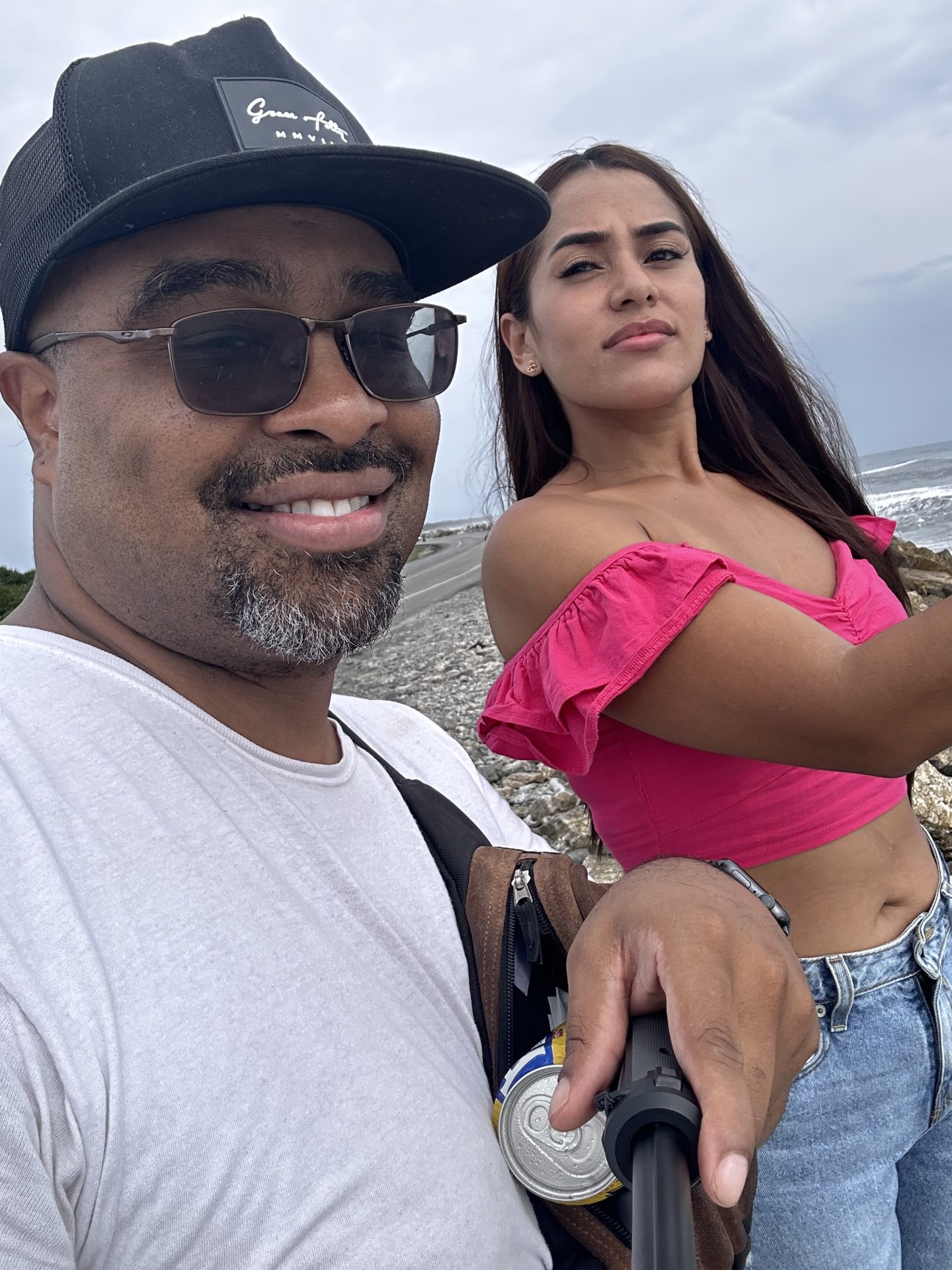 Two people taking a selfie on a beach.