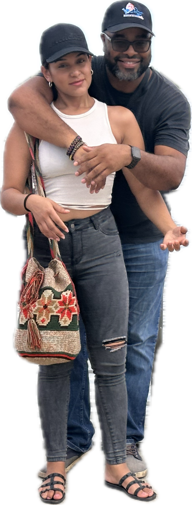 Smiling couple posing for a photo outdoors.